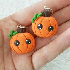 two small orange pumpkins with black eyes on them