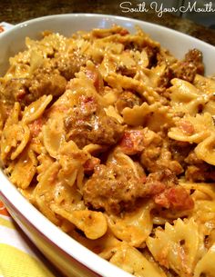 a white bowl filled with pasta and meat