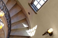 an overhead view of a spiral staircase in a building with two lights on each side