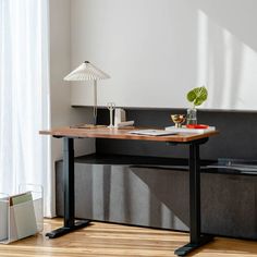 a desk with a lamp and some books on it