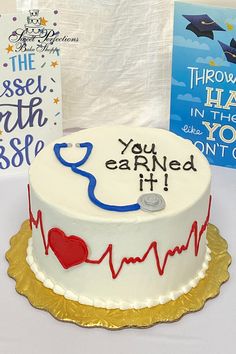 a cake with a stethoscope on it next to some books