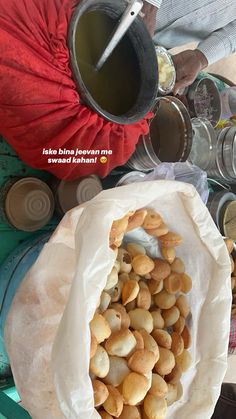 a bag full of food sitting on top of a table next to cans and cups