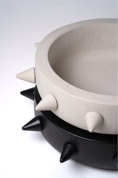 a black and white bowl with spikes on it