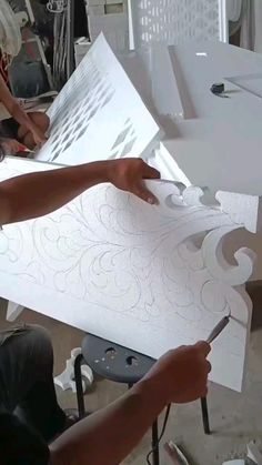 two people are working on some art work