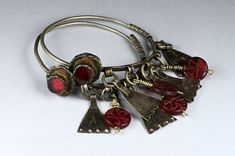 "Antique Berber silver earrings finely decorated with enamels and dark red glass beads embedded in the center of the hooks.  There are antique niello pendants and circular-shaped engraved red glass beads hanging from the lower edge of the hooks. The diameter of the circles measures 2.36 inch (6 cm), while the overall height of the earrings measures 3.54 inches (9 cm). Beautiful antique patina. Provenience: Morocco. Total weight (2 earrings): 29.57 gr. Back to \"Earrings\" section: https://www.et Antique Red Dangle Jewelry, Vintage Etched Dangle Jewelry, Metal Dangle Jewelry With Etched Details, Etched Metal Dangle Jewelry, Antique Red Nickel-free Jewelry, 2 Earrings, Enamels, Silver Enamel, Red Glass