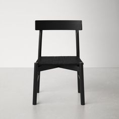 a black chair sitting on top of a white floor