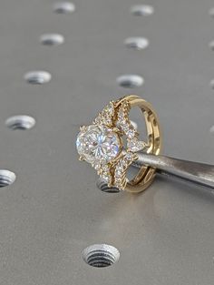 a pair of diamond engagement rings on top of a table