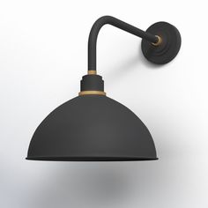 a black and gold wall light against a white background with clippings to the side