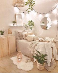 a bedroom with white walls and wooden flooring, plants in baskets on the bed