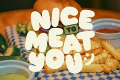 a close up of food on a table with the words nice to meat you over it