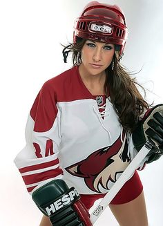 a female hockey player is posing for the camera