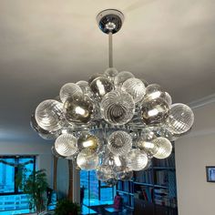 a chandelier hanging from the ceiling in a living room