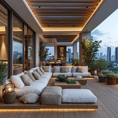 an outdoor living area with large couches and potted plants