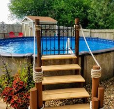 an above ground swimming pool with steps leading up to it and a roped in deck