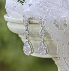 "Pretty crystal bridal earrings will add sweet sparkle to your wedding day. High quality marquise cubic zircon crystals in a leafy design are completed with a crystal teardrop, creating a stunning earring which is light and comfortable to wear. 💜 Available in rose gold, silver (rhodium) and gold Elegant and sophisticated! Measurements: Length - 1.57\" (4cm) 💙 Don't have pierced ears? We have earrings converters that convert post backs and french hooks to clip on in both gold and silver tone. A White Teardrop Earrings With Prong Setting For Wedding, Pear-shaped Diamond Accented Bridal Earrings, Pear-shaped Bridal Earrings With Diamond Accents, Pear-shaped Prong Set Bridal Earrings For Wedding, Elegant Marquise Teardrop Earrings For Wedding, Diamond White Teardrop Crystal Earrings For Wedding, Diamond Drop Crystal Earrings For Wedding, Diamond White Marquise Bridal Earrings For Wedding, Pear-shaped Teardrop Earrings With Prong Setting For Wedding