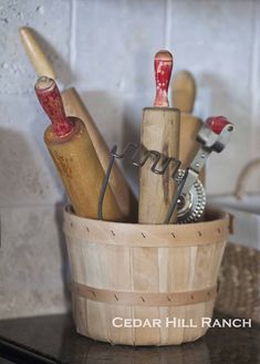 a basket filled with different types of kitchen utensils on top of a counter