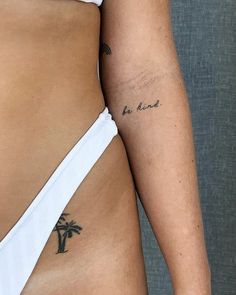 a woman with a tattoo on her left arm and the other side of her stomach