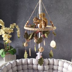 a teddy bear sitting on top of a bed next to pillows and flowers in a room