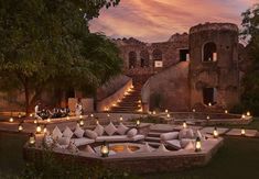 an outdoor seating area with candles lit in front of it and the words six series fort bar