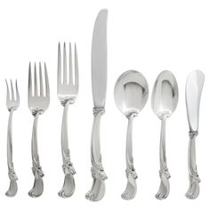 an assortment of silverware including forks, knives and spoons on a white background