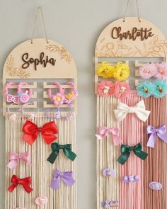 two wooden wall hangings decorated with bows and hair clips, one has the word sophia on it