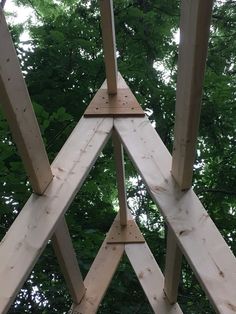 a wooden structure in the middle of some trees