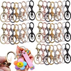 a hand holding a bunch of keys with smiley faces on them and an emoticive keychain in the middle