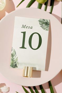 a table number on a plate with flowers