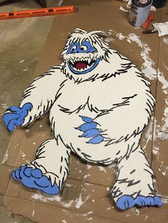 an image of a bigfoot on the ground with paint all over it's body