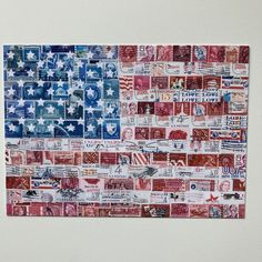 an american flag made out of postage stamps on a white wall with red, white and blue colors