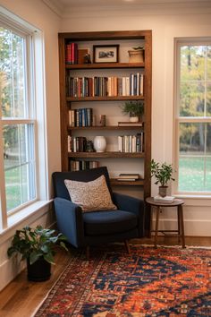 a living room filled with furniture and bookshelves next to a large open window