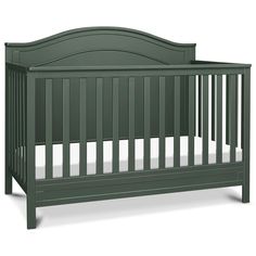 a green crib with white sheets on the bottom and side rails, in front of a white background