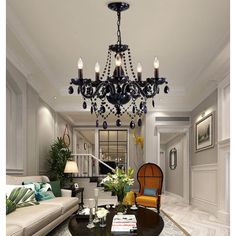 a chandelier hanging from the ceiling in a living room