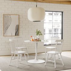 a white table and four chairs in a room