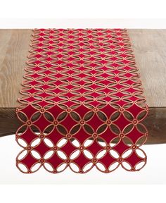 a red table runner on top of a wooden table