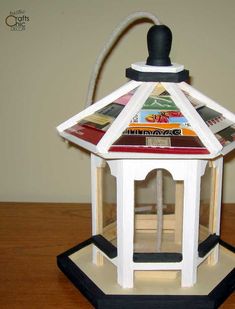 a small white lantern on top of a wooden table