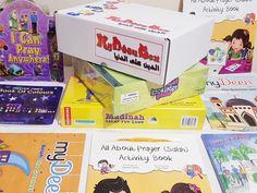 several children's books are stacked on top of each other in front of a box