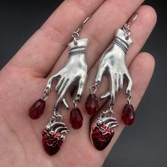 Drench your ears with these sultry Bleeding Heart Earrings with Red Blood Drops! Make a statement with these romantic gothic earrings, and let everyone know you have a heart of darkness. 'Tis a (blood) thirsty accessory to add to your wardrobe! Metals Type: Zinc alloy Vampire Ghost, Just Aesthetic, Witchcraft Jewelry, Dripping Blood, Vampire Earrings, Blood Drop, Gothic Vampire, Carved Heart, Red Blood