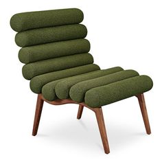 an upholstered green chair with six pillows on it's back and legs