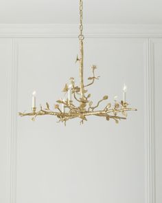 a chandelier hanging from a ceiling in a room with white walls and flooring