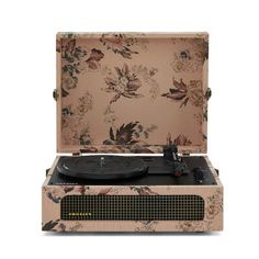 an old - fashioned record player with floral wallpaper on the back and side panels