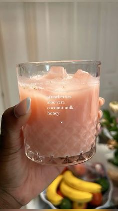 a person holding up a glass with some fruit in it and a quote on the side