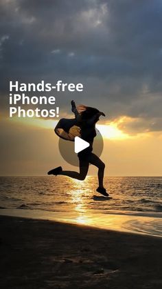 a person jumping into the air on top of a beach