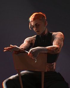 a man with tattoos sitting in a chair