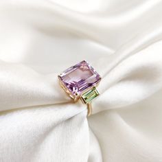 This stunning ring is set in 14k Solid Yellow Gold with Natural Pink Amethyst and Peridot with utmost precision. It is an unique statement gemstone ring for nearly every occasion and is completely hassle-free jewelry. ITEM DETAILS * Center Gem: Pink Amethyst  * Gem Size: 10x12mm * Gem Shape: Octagon * Side Gem: Peridot * Gem Size: 3x6mm * Gem Shape: Baguette * Gem Weight: 7.21 carats * Gold Purity: 14KT * Gold Weight: 2.10 gram * Total Weight of the Ring: 3.54 gram The Gold purity is guaranteed and it comes with authentic 14KT gold hallmark. Since my items are handmade, they are absolutely nickel and lead free. CUSTOMIZATION: * Size Customization is available for this ring and it is available in all ring sizes. Kindly choose your ideal ring size from the drop-down. * Gemstone customization Amethyst And Peridot Ring, Green Amethyst Ring In 14k Gold, Green Amethyst Rings In Fine Jewelry Style, Green Amethyst Ring Fine Jewelry, Fine Jewelry Amethyst Ring For May Birthstone, Amethyst And Peridot, Handmade Jewelry Box, Amethyst Gem, August Birthstone