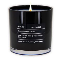 a candle that is sitting on top of a white surface with the words soy candle written in black