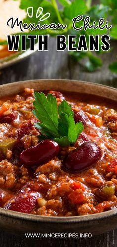 mexican chili with beans in a bowl on a wooden table next to bread and cilantro