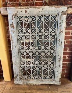 an old window that is on the side of a brick wall