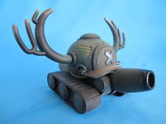 a small toy tank with antlers on it's head and eyes, sitting on a blue background