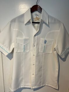 Vintage 1970s Iolani Executive Hawaiian Mens SS Button Up Shirt Size Medium, White with Light Blue Stripping Excellent Condition, like new!  Feel free to message with any additional sizing questions! Retro White Button-up Camp Shirt, Vintage Blue Camp Shirt With Button Closure, Vintage White Collared Camp Shirt, Vintage White Shirt With Button Closure, Vintage Fitted White Camp Shirt, White Fitted Vintage Camp Shirt, Fitted White Vintage Camp Shirt, Retro White Button-up Shirt, White Retro Button-up Shirt